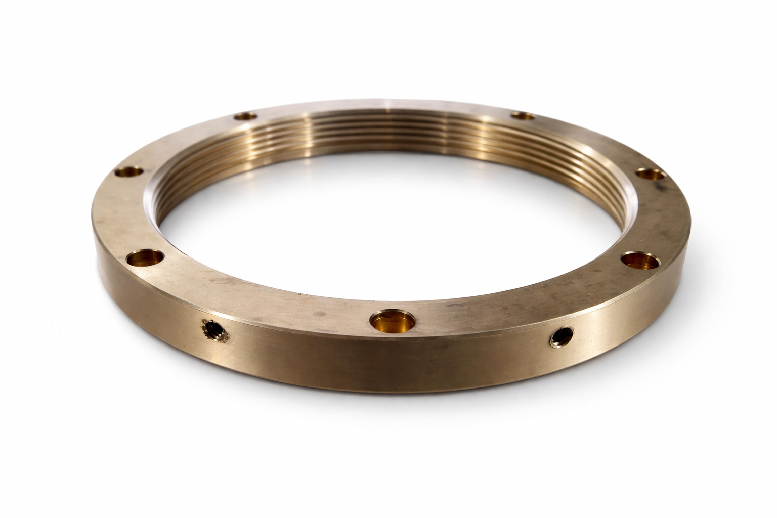 Precision brass retaining ring with internal threads and evenly spaced mounting holes, used in industrial and mechanical assemblies.